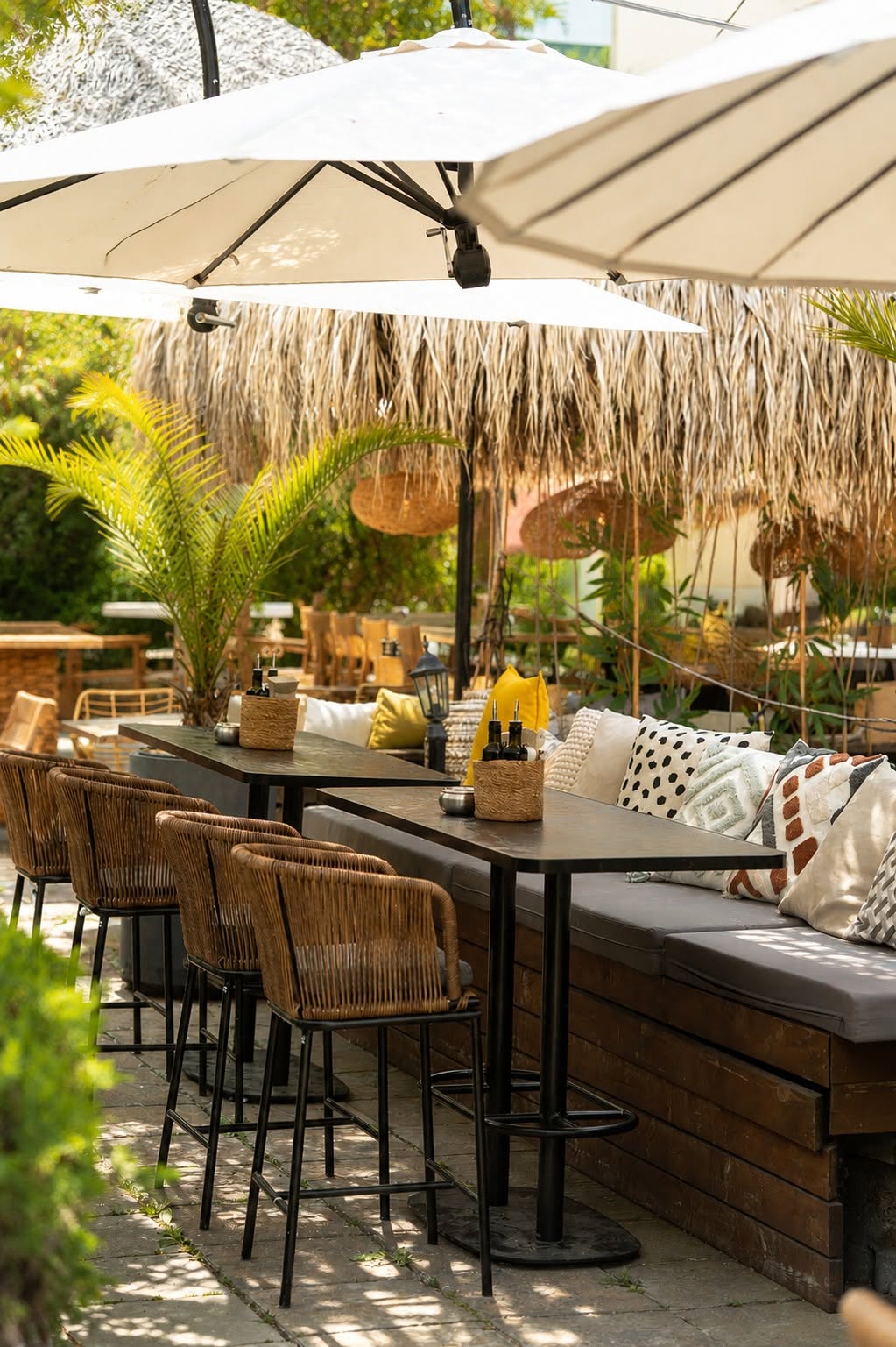 Incanto garden restaurant in Burgas with palms, parasols and cushioned seating