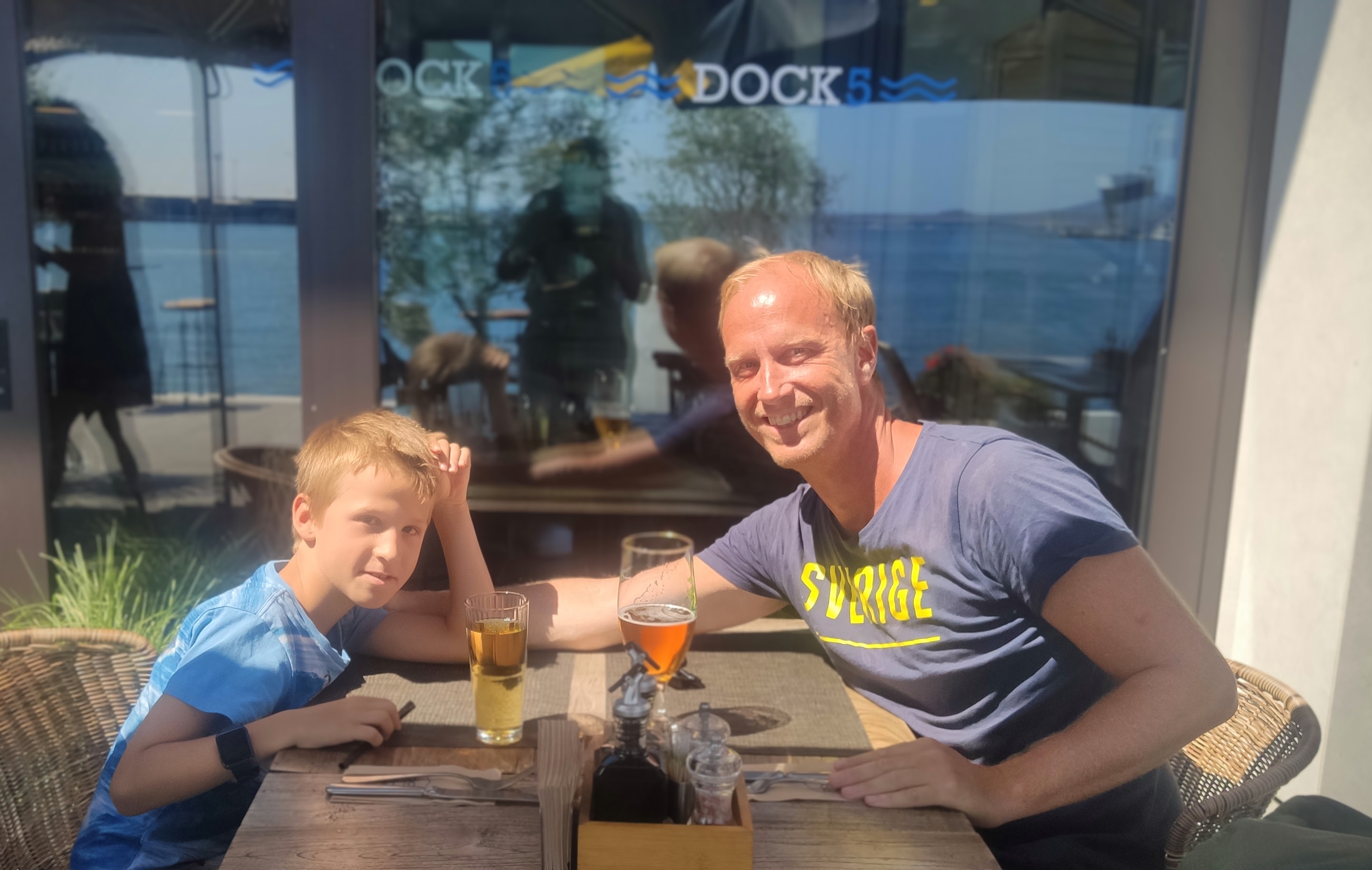 Per Åkerblom and his son at a seafront restaurant in Burgas, the Black Sea behind them